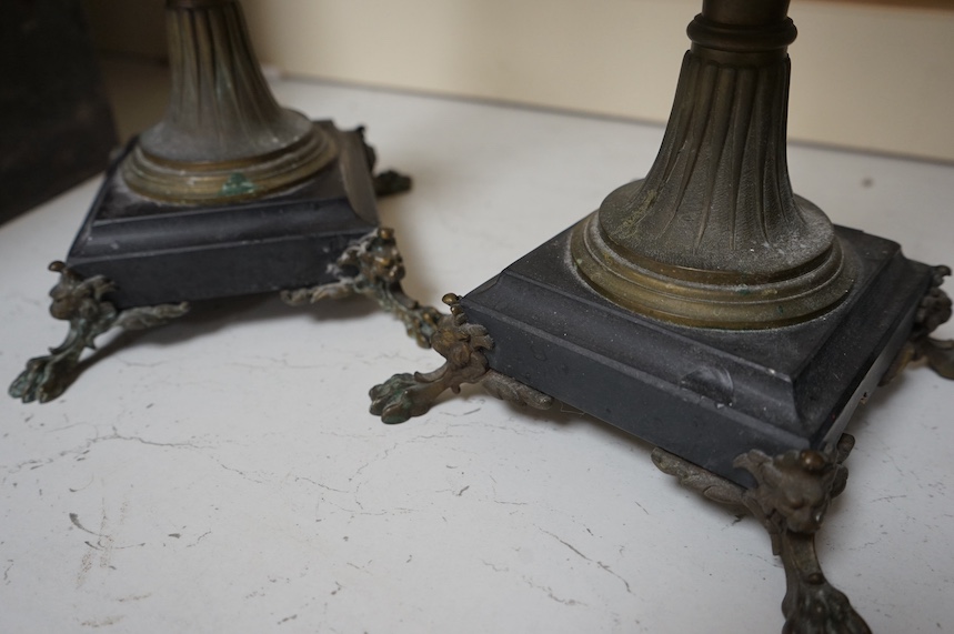 A pair of four branch candelabra raised on slate bases with paw feet, 62cm high. Condition - fair/good